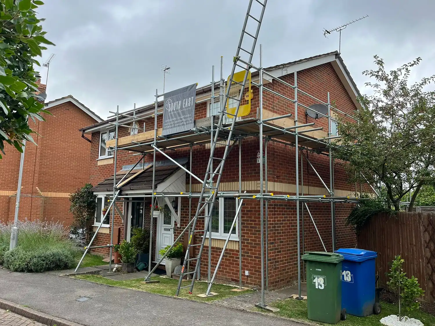 A house with scaffolding on the front of it.